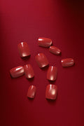 Basic but Make It Boss square press-on nails in a deep red, glossy finish with subtle shimmer.