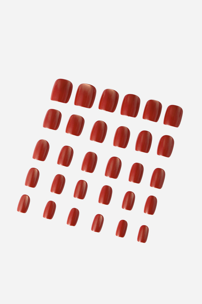 A set of 24 short square press-on nails in a glossy wine-red color.