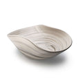 Sand-colored serving bowl with organic curved shape and swirled surface texture.