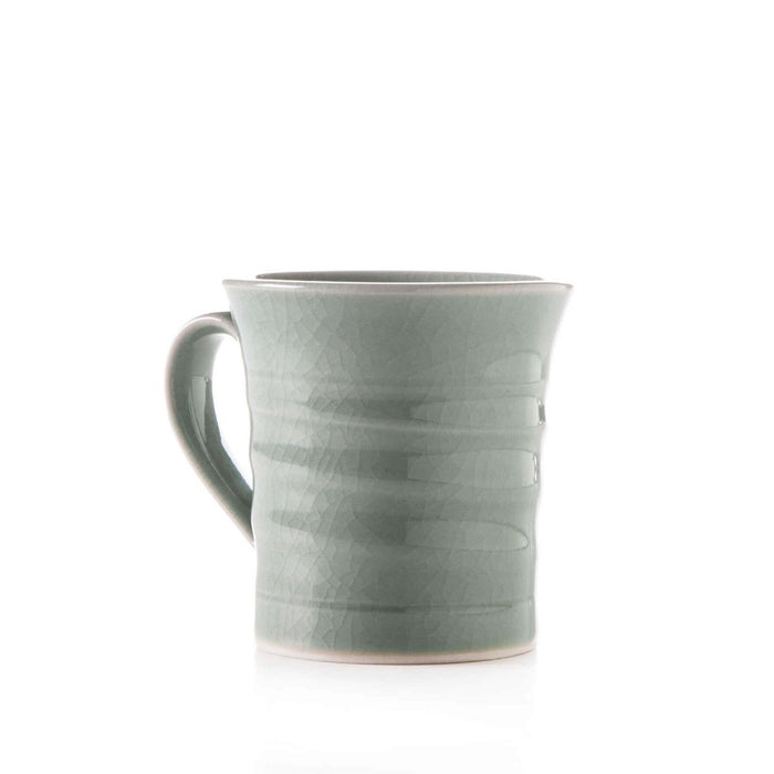 Celadon ceramic mug with crackle glaze finish and horizontal ridged detail on body.