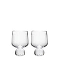 Two clear glass cups with rounded bowls and bulbous bases on white background.