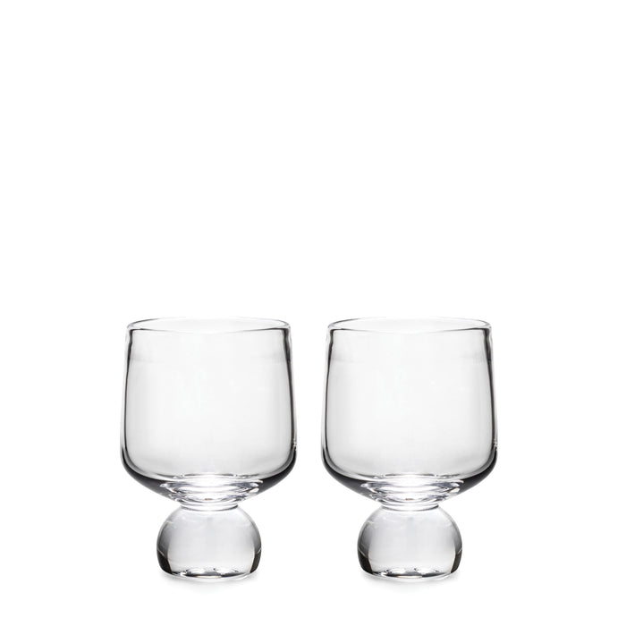 Two clear glass cups with rounded bowls and bulbous bases on white background.