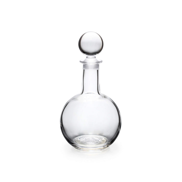 Clear glass decanter with a rounded body, narrow neck, and spherical stopper.