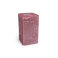 Deep berry-colored square pillar candle with white wick and textured wax surface.