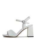 A pair of stylish and comfortable women's white block heel sandals, featuring the Aina block heel design.