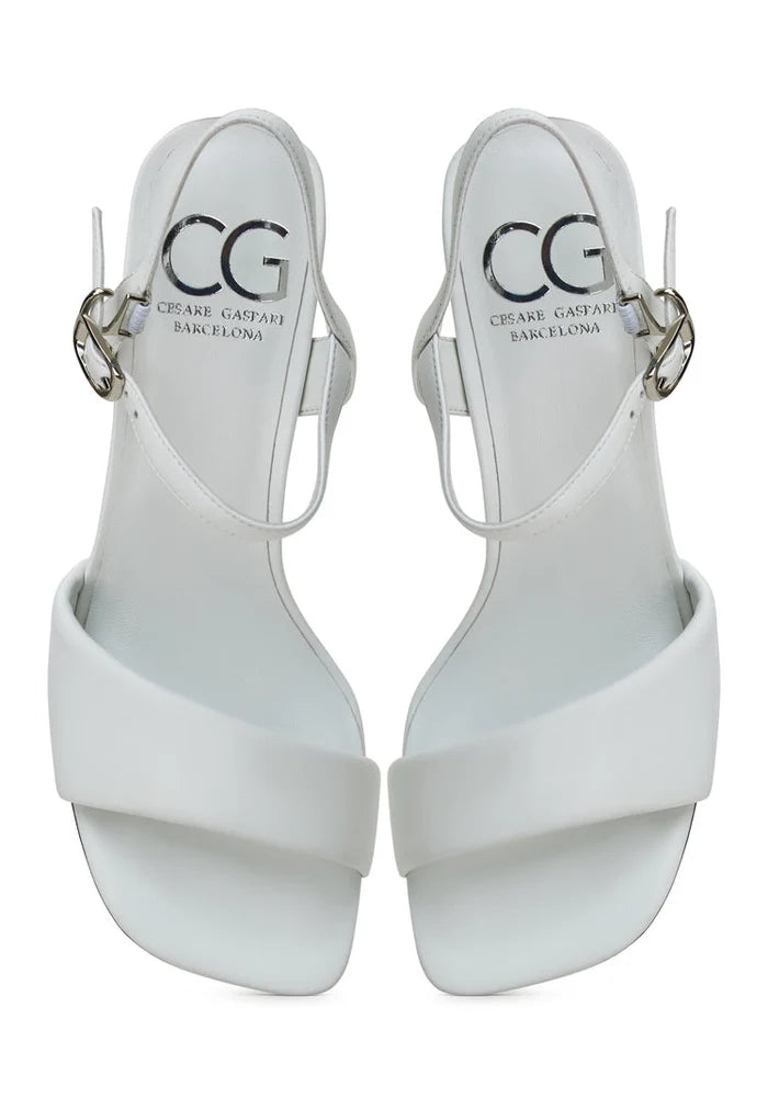 A pair of stylish and comfortable white block heeled sandals for women, featuring the Aina design.