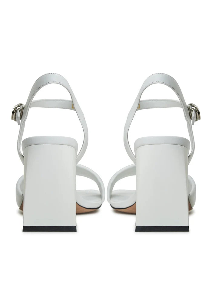 A pair of stylish white block heeled sandals, perfect for women - the Aina block heel sandals, providing both style and comfort.