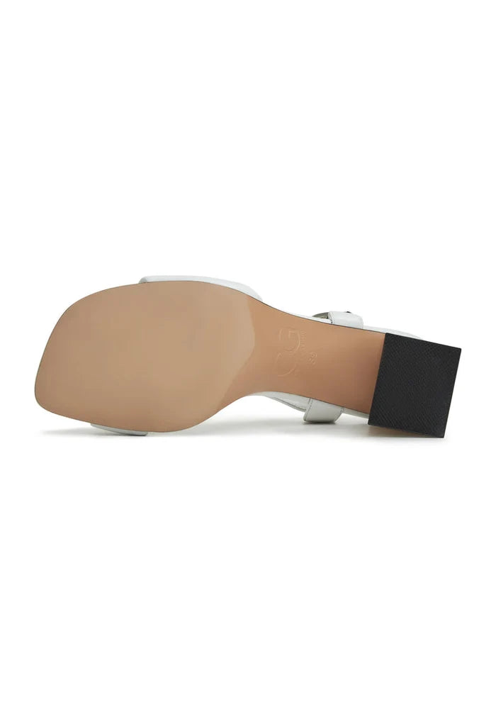 A pair of white Aina block heeled sandals for women, stylish and comfortable for all-day wear.