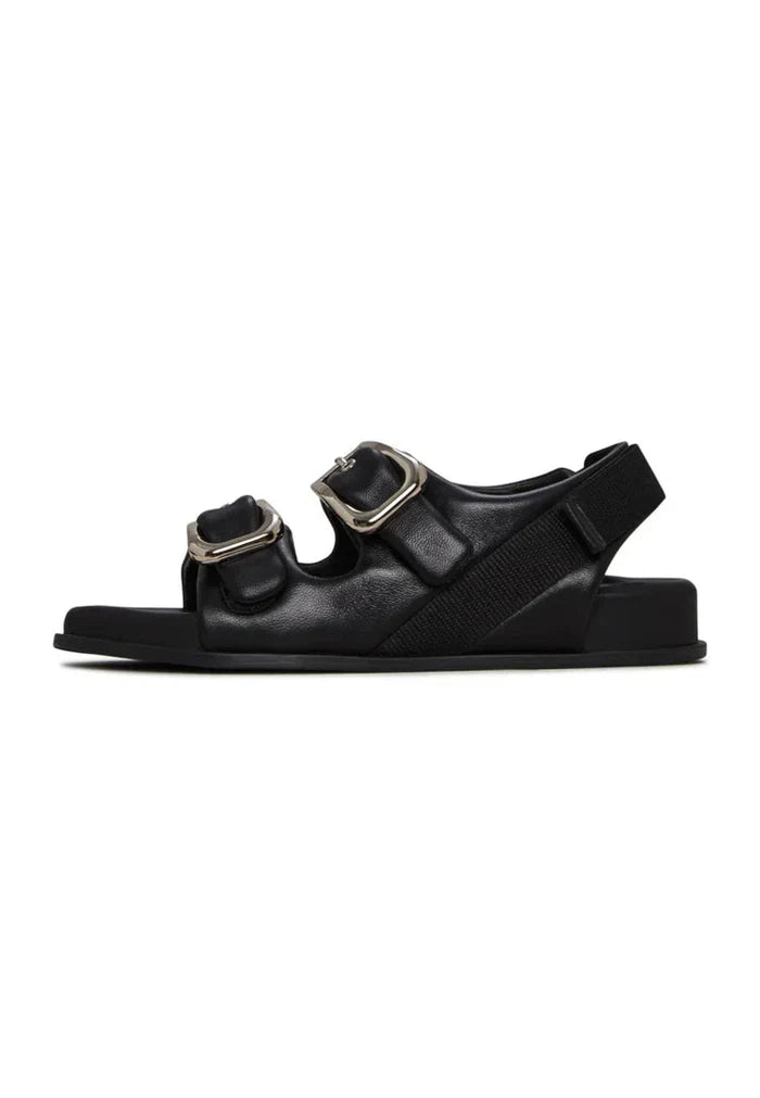 A stylish pair of bold black buckle wedge sandals for women, perfect for making a fashion statement.