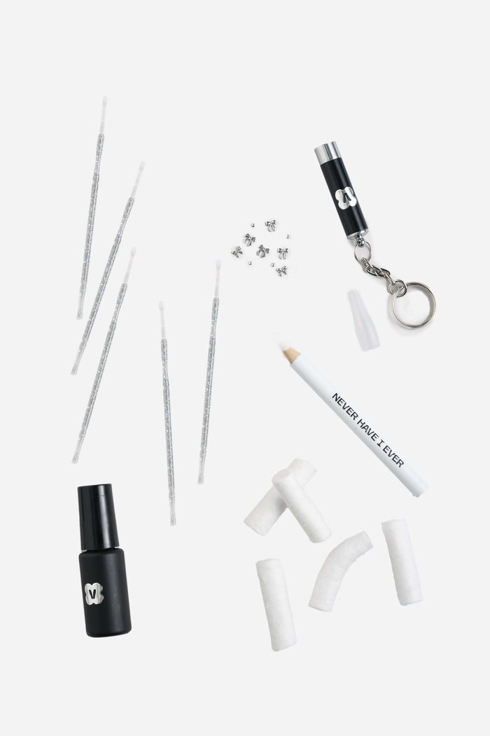 BOW BABY DIY Tooth Gem Kit contents including gems, glue, UV light, applicators, and pencil picker.