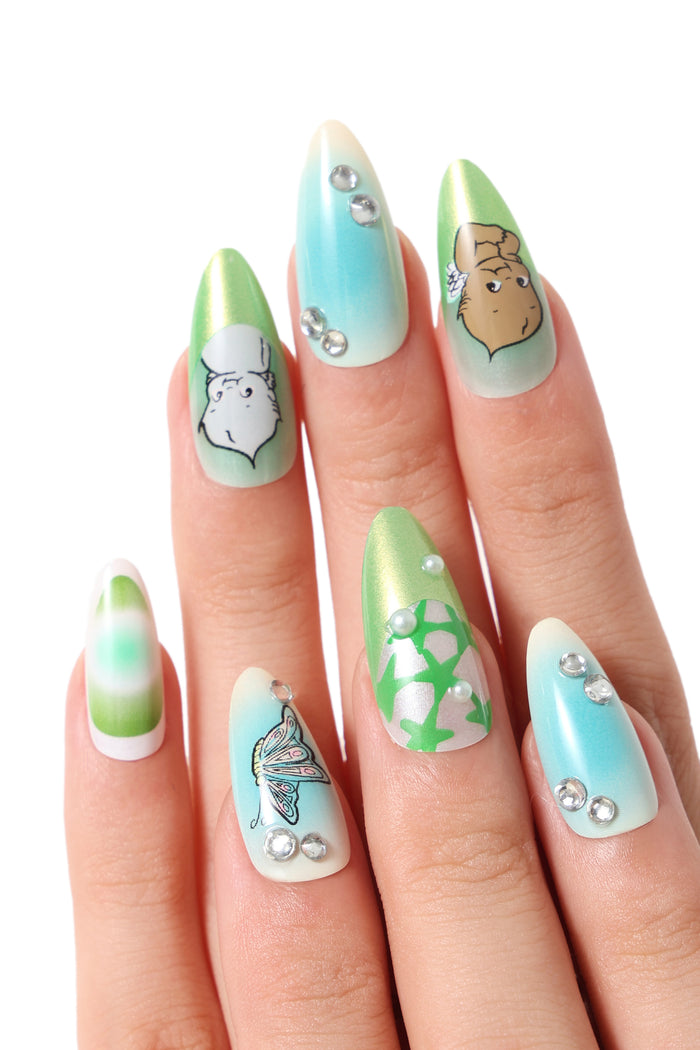 Press-on nails with green and blue gradient, featuring Kewpie characters, butterflies, and gem accents.