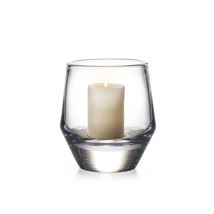Clear glass hurricane vase with cream pillar candle inside.