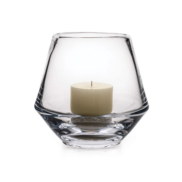 Clear glass hurricane vase with tapered sides holding a cream-colored pillar candle.