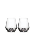 Two clear stemless wine glasses with tapered sides and rounded bases.