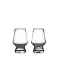 Two clear glass tasting glasses with tapered bowls and weighted bases.