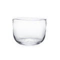 Clear glass bowl with wide rounded sides and flat bottom.
