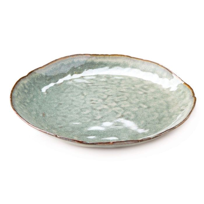 Moss green ceramic plate with speckled glaze, rustic brown rim, and organic wavy edges.