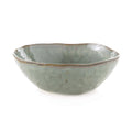 Sage green ceramic bowl with wavy rim and textured glaze finish.