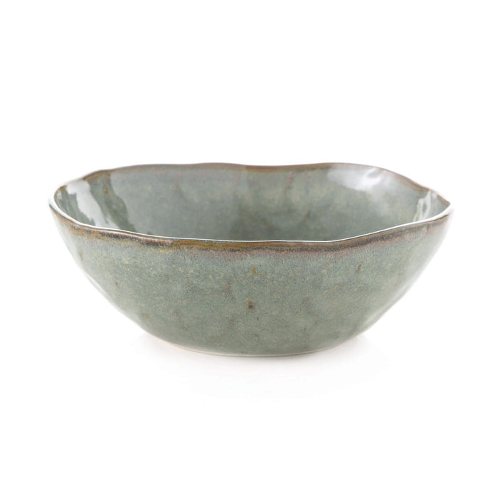Sage green ceramic bowl with wavy rim and textured glaze finish.