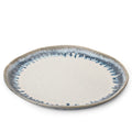 Round ceramic dinner plate with cream center and blue-grey brushstroke border pattern.