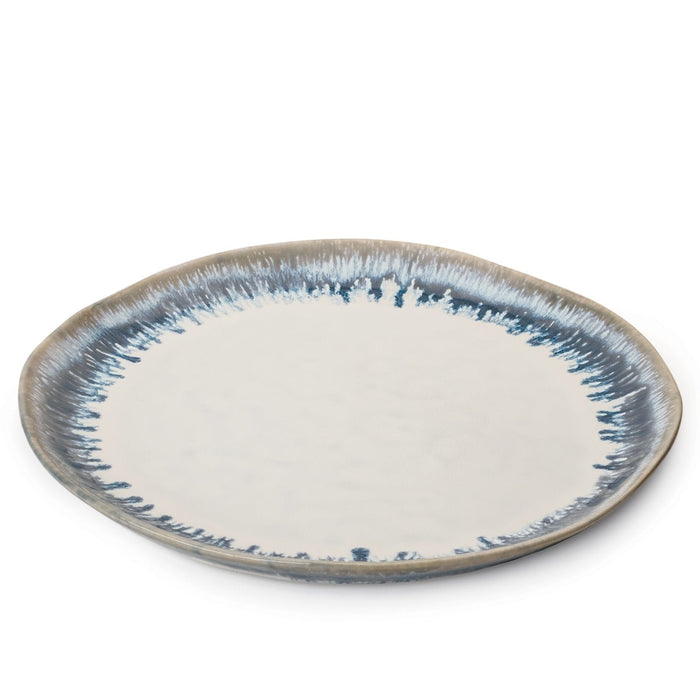 Round ceramic dinner plate with cream center and blue-grey brushstroke border pattern.
