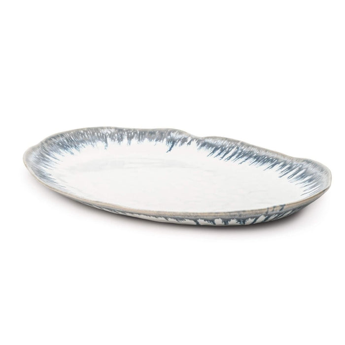 Oval ceramic platter with blue brushstroke pattern on white background and rim.