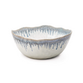 White ceramic serving bowl with blue drip glaze pattern and wavy rim edge.