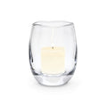 Clear glass hurricane vase with cream-colored pillar candle inside.
