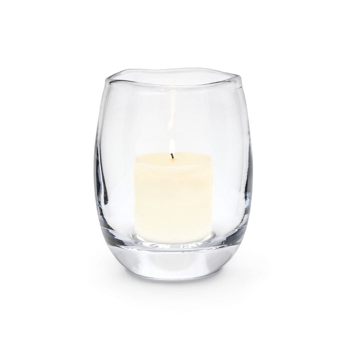 Clear glass hurricane vase with cream-colored pillar candle inside.