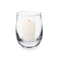 Clear glass hurricane vase containing a cream-colored pillar candle with single wick.