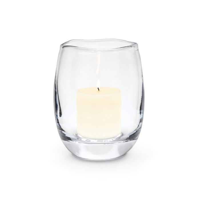 Clear glass hurricane candle holder with cream-colored pillar candle inside.
