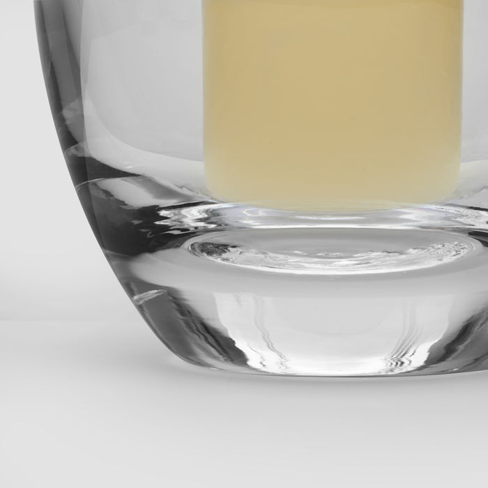 Clear glass hurricane vase filled with pale yellow liquid, shown with white gift box packaging.