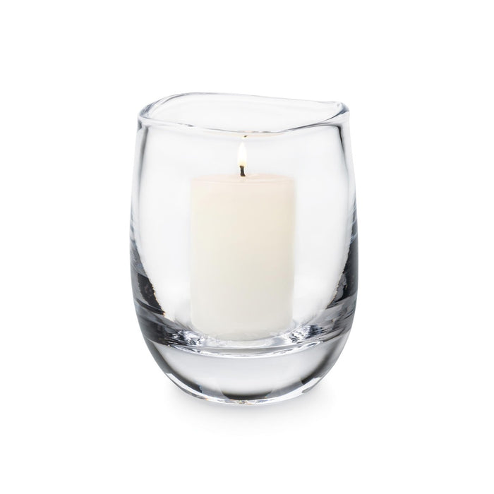 Clear glass hurricane vase with cream-colored pillar candle inside.