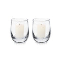 Two clear glass hurricane candleholders with cream-colored pillar candles inside.
