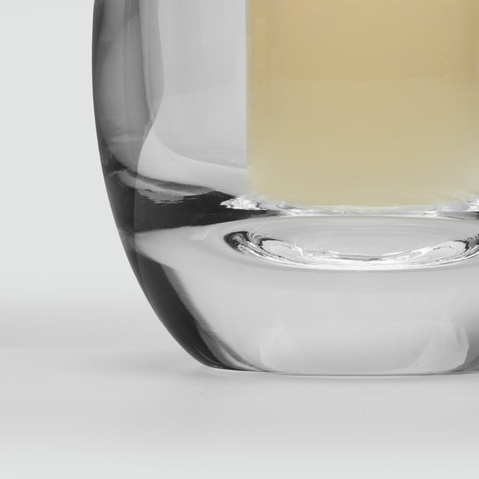 Clear glass hurricane vase with black band detail and cream-colored candle inside.