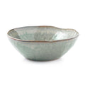 Moss green ceramic pasta bowl with organic wavy rim and mottled glaze finish.