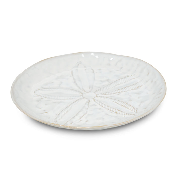 White side plate with sand dollar relief design and beige rim.
