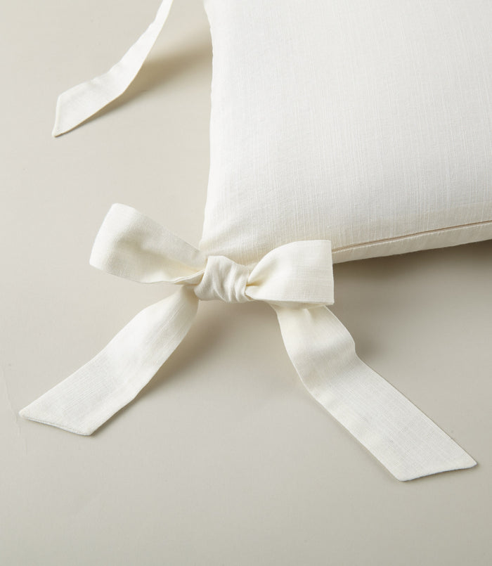 Detail of ribbon ties on the Windsor Stripe Oblong Pillow in Pearl