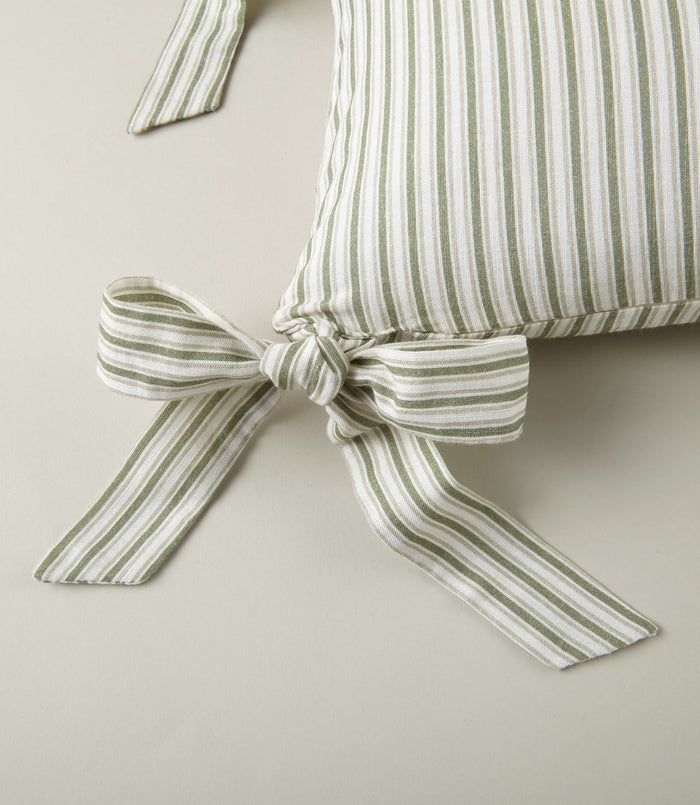 Detail of ribbon ties on the Windsor Stripe Oblong Pillow in Moss
