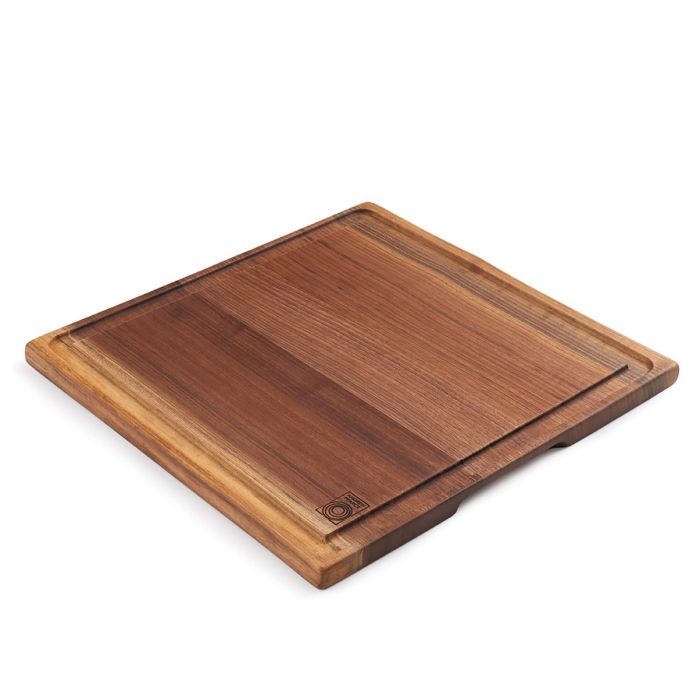 Square black walnut carving board with recessed groove and rounded edges.