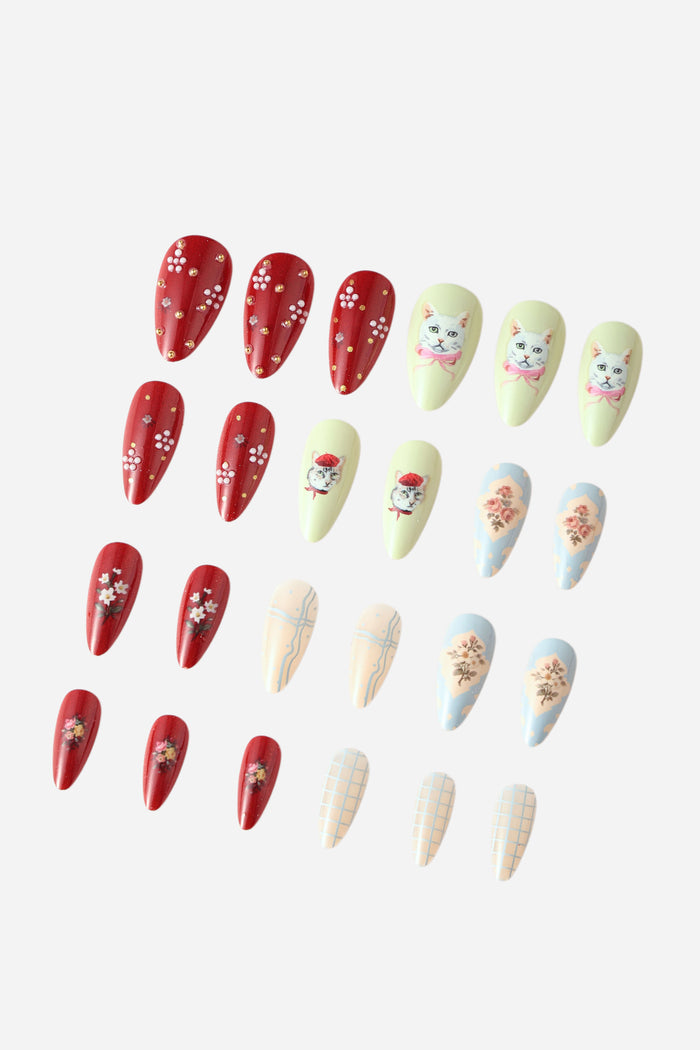 Almond press-on nails with cat collage, floral, and plaid designs in red, pastel green, and blue.
