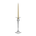 Tall candlestick with cream taper candle, clear glass stem, wide drip pan, and weighted base.