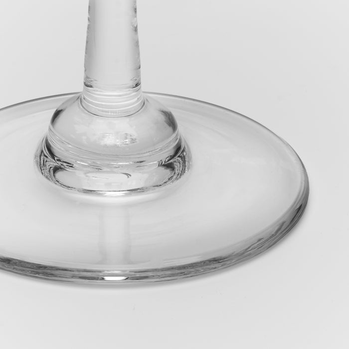 Clear glass candlestick with a tapered stem and wide circular base, shown from above against a neutral background.