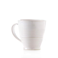 White ceramic mug with handle and horizontal band detail around lower body.