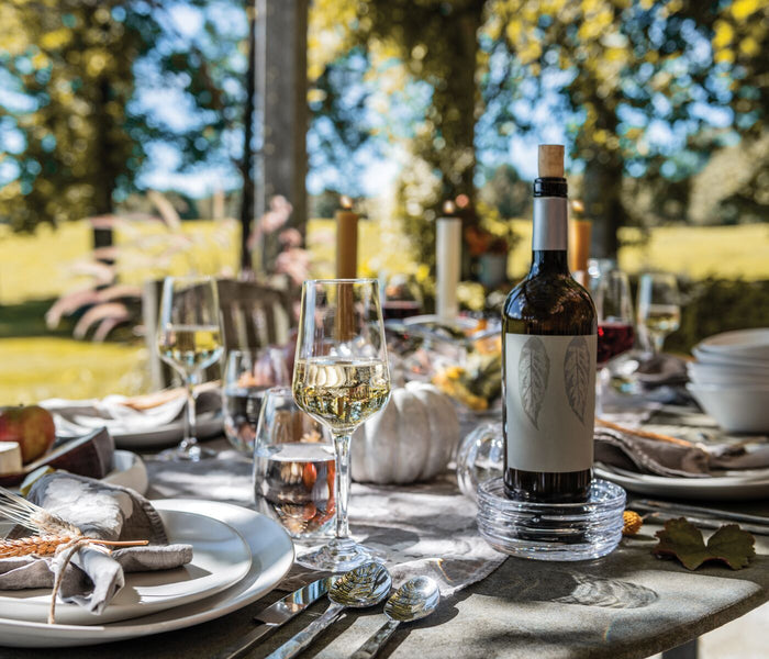 Five-piece flatware set with fork, knife, spoon, and additional utensils displayed on outdoor dining table.