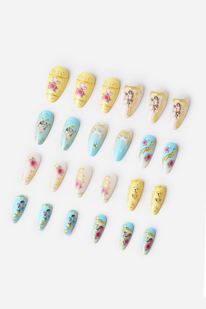 Cherub Rococo almond press-on nails feature pastel colors with cherub and floral designs.