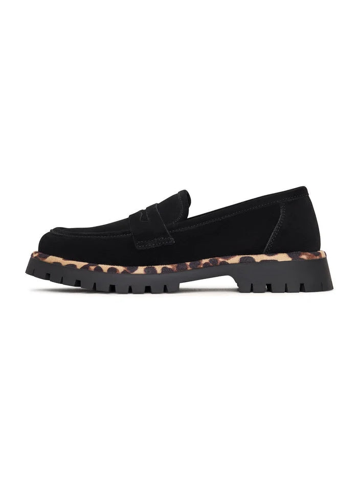 A pair of chic black loafers with a chunky sole, known as Lily black loafers, a stylish and fashionable choice in footwear.