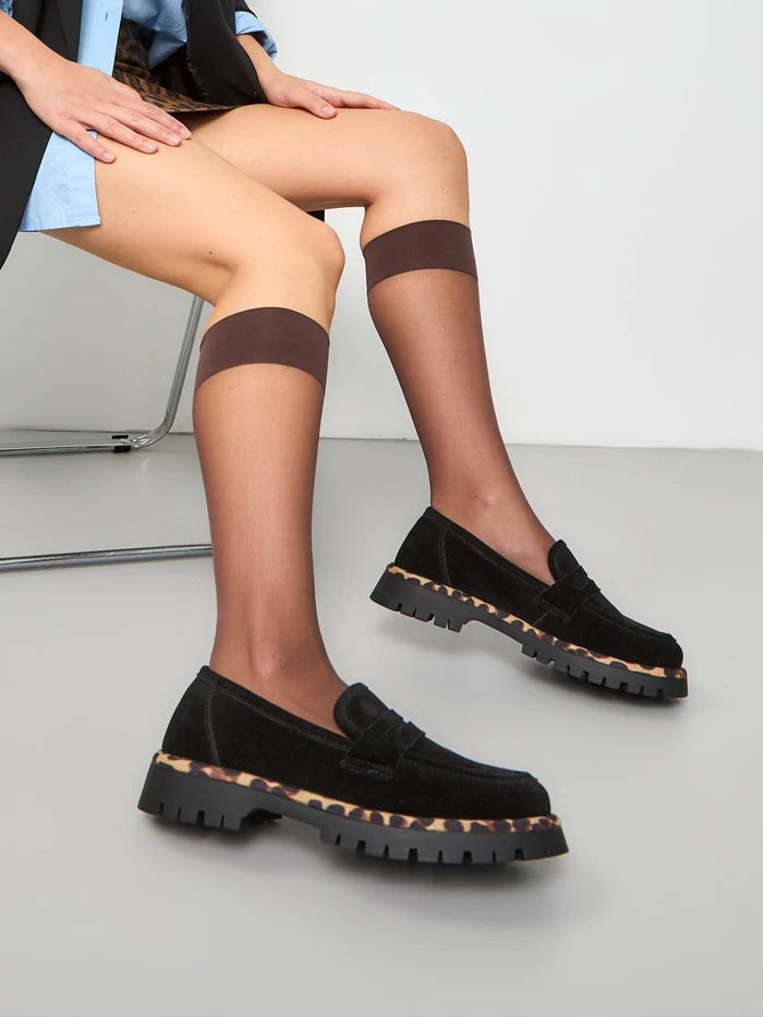 A pair of black chunky sole loafers, known as Lily black loafers, offering a chic and stylish option in fashionable footwear.