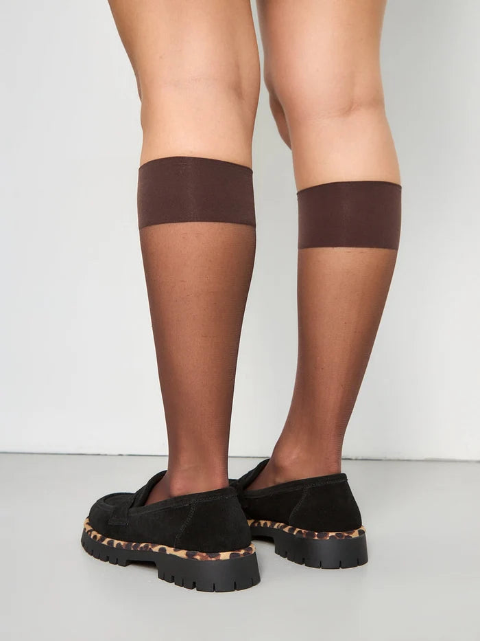 A trendy pair of Lily black loafers with a chunky sole, perfect for a chic and fashionable look.