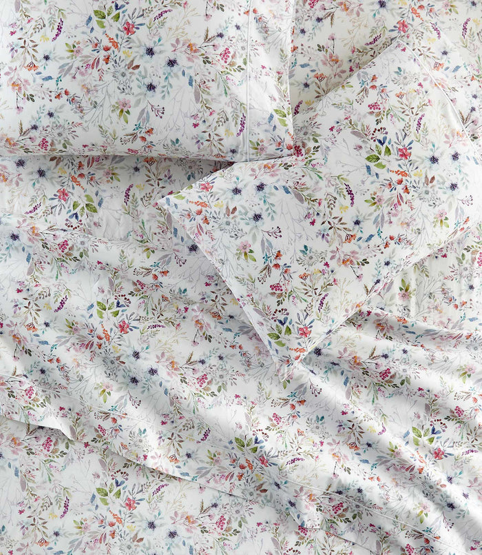 Chloe percale floral print pillowcases and sheets on a bed, Floral